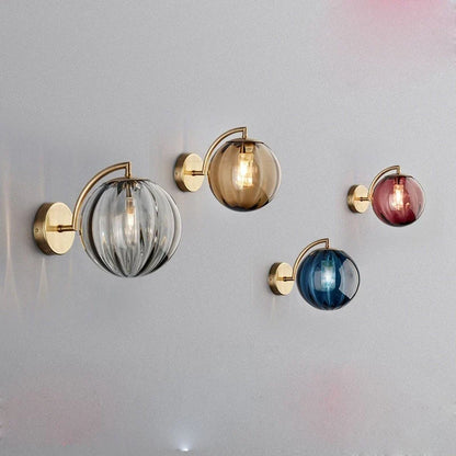A Curved Brass Arm Holds a Glass Globe