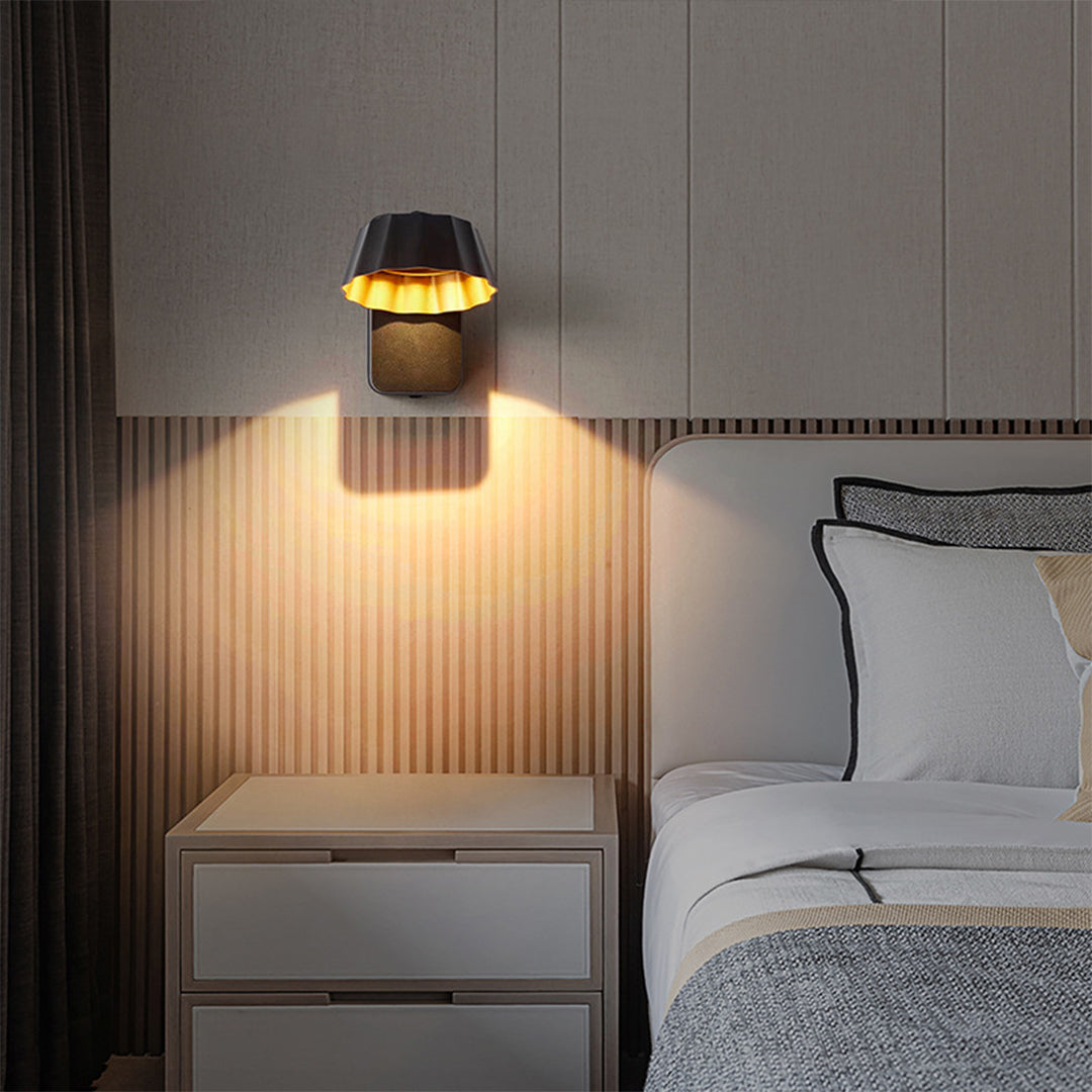 Contemporary bedroom wall sconce providing task lighting above nightstand with warm glow