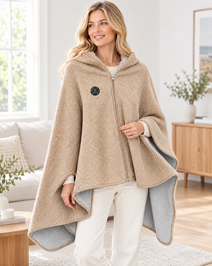 Woman wearing a beige heated cape shawl with a zip front