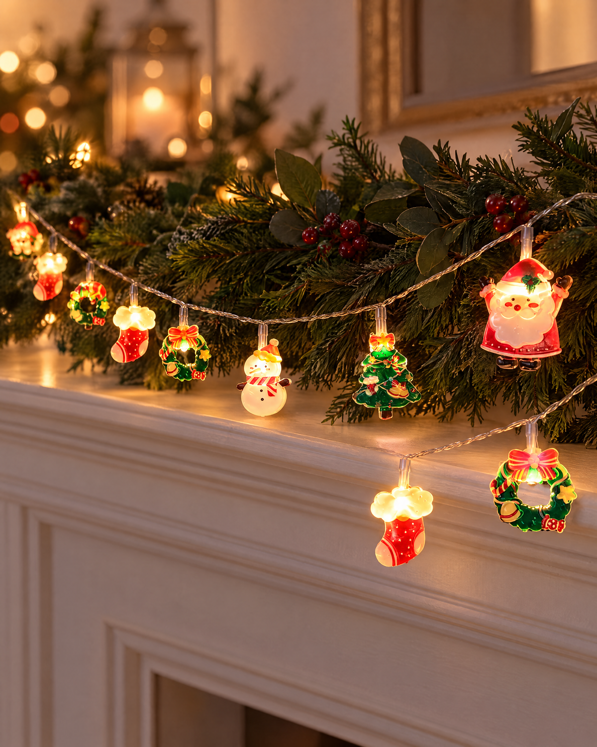 Santa and snowman LED string lights draped along a mantel with greenery