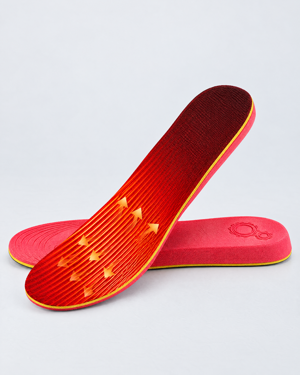 Red USB rechargeable heated insoles on a light grey surface