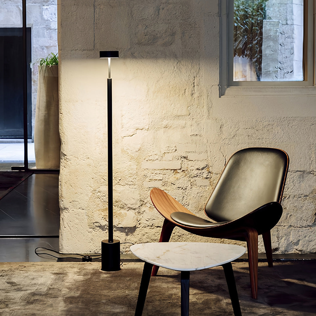 Industrial-style LED petite floor lamp in loft setting showcasing versatile lighting for creative workspace environments
