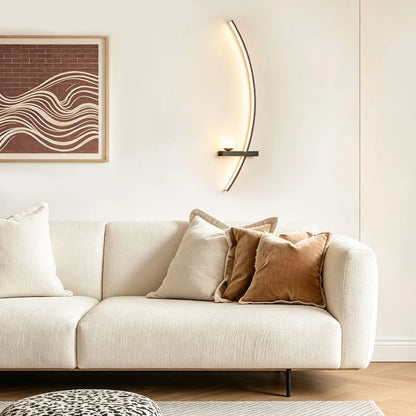 LED curved wall light installed above a sofa in a modern living room with a warm minimalist design.
