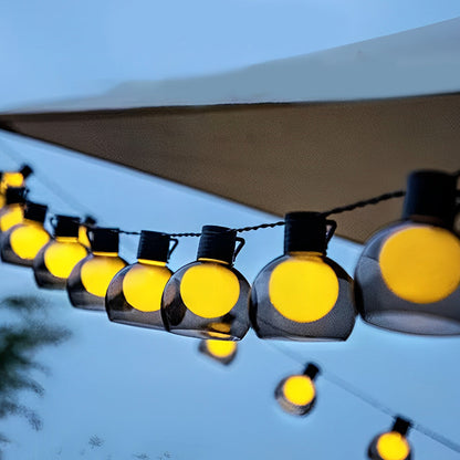 Close-up of LED globe string lights with warm bulbs, highlighting the texture and glow of outdoor decorative lighting.