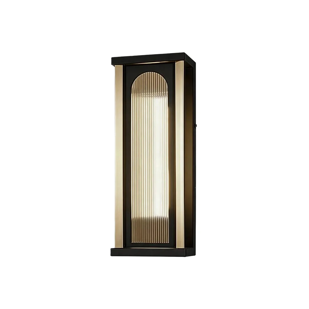 Medium outdoor wall sconce with black frame and warm ribbed glass shade