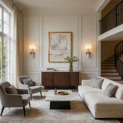 Modern gold wall sconce lighting glowing in a sophisticated living room with classic panels.