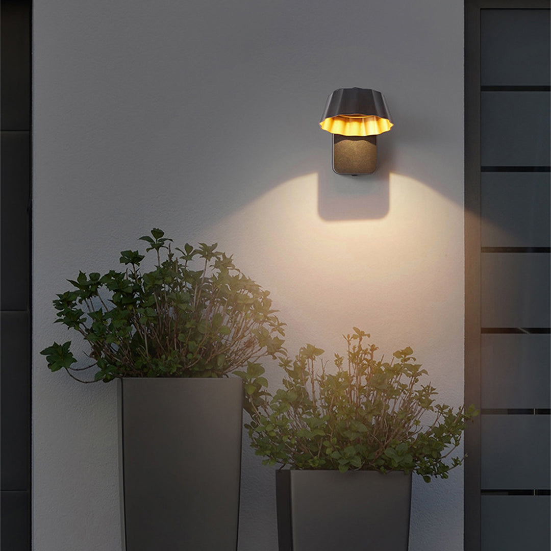Outdoor wall lighting on modern home exterior with landscaping and evening ambiance