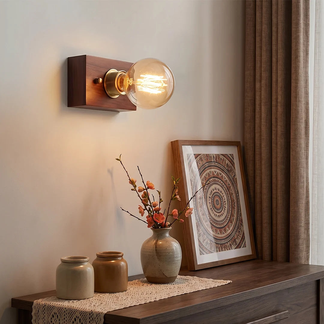 Retro bedside wall light with a wood backplate and exposed bulb mounted above a console table.