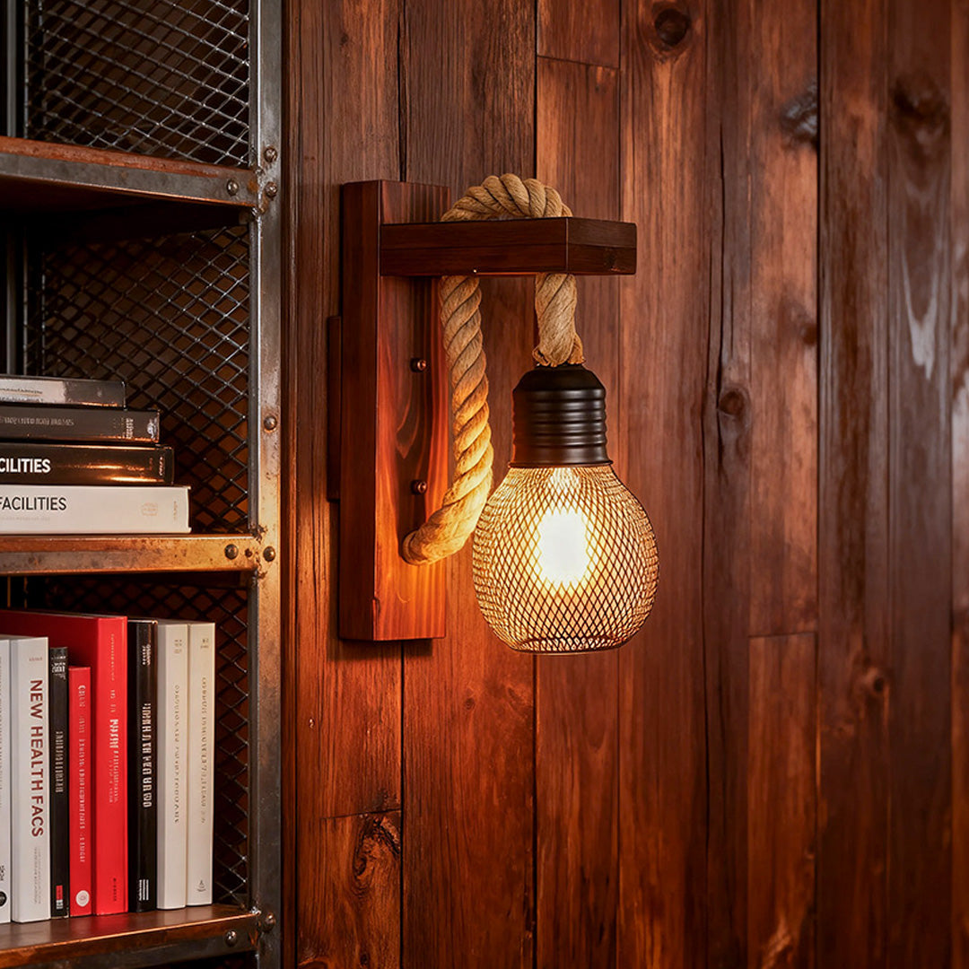 Rustic wall light mounted on a textured wooden panel, casting a warm glow over a dark industrial bookshelf.