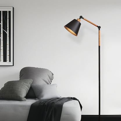 Scandinavian metallic floor lamp with white shade and natural wood accents in cozy bedroom environment