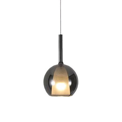 Single glass ball pendant light with a warm glow, perfect for cozy and intimate dining spaces.