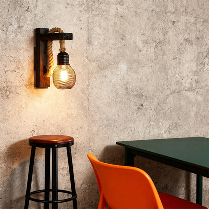 Single rustic wall light with a dark wood backplate and braided rope accent, featuring a vintage caged filament bulb.