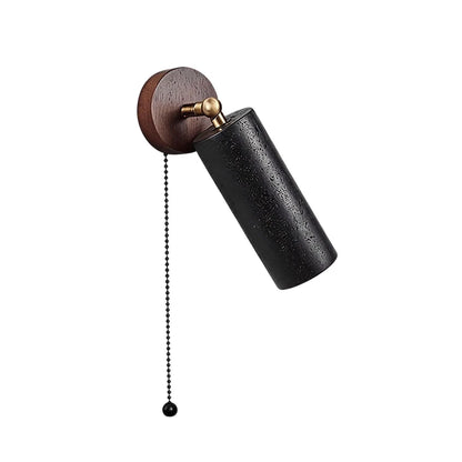 Spotlight wall light featuring an adjustable black cylinder, wood backplate, and pull-chain switch.