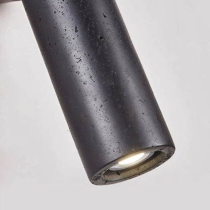 Close-up of spotlight wall lights featuring a textured black cylindrical shade and recessed light source.