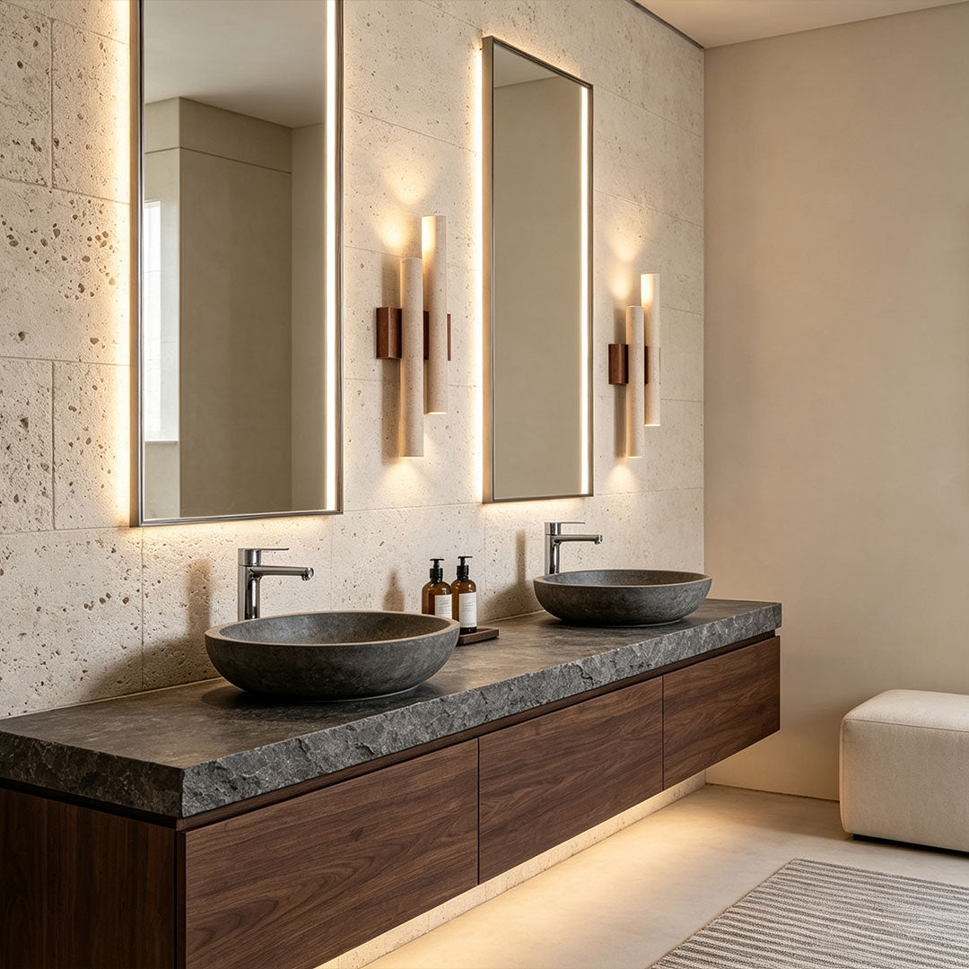 Stone wall lighting installed beside bathroom mirrors, adding elegant accent lighting to a luxury vanity area.
