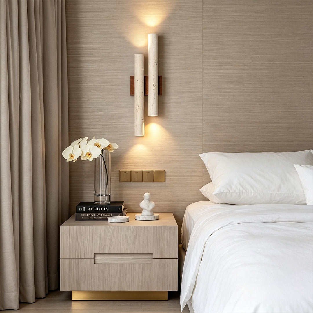 Stone wall lighting mounted beside a bed, providing warm ambient illumination in a modern bedroom interior.