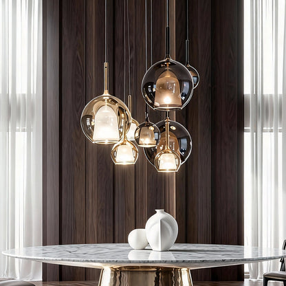 Three glass ball pendant lights hanging above a dining table, adding sophistication to a modern interior.