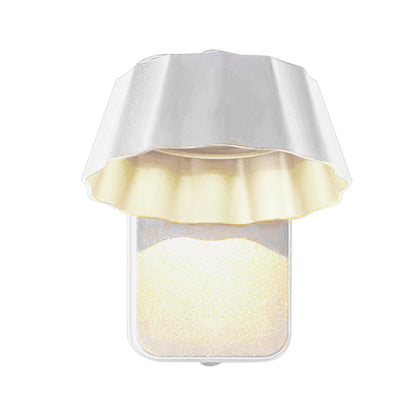 Illuminated white wall sconce with umbrella-style shade casting soft ambient light