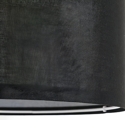 Close-up detail of small black pendant light showing woven fabric texture and premium construction